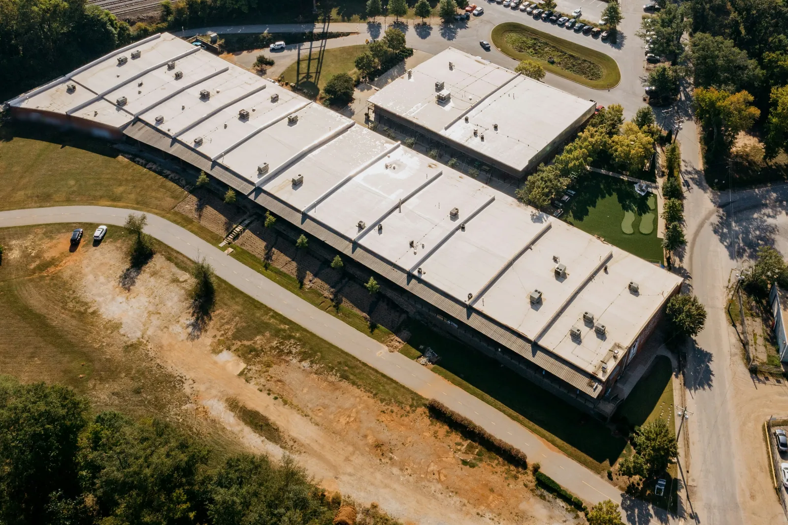 Aerial view of a white flat TPO roof on a commercial building